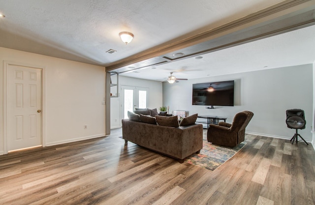 12103 Moorcreek Dr, Houston, TX 77070 - living room with wood finished floors, a ceiling fan, baseboards, and a textured ceiling