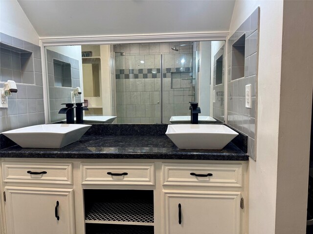 12103 Moorcreek Dr, Houston, TX 77070 - full bathroom with backsplash, double vanity, a shower stall, and tile walls