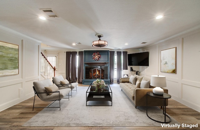 12103 Moorcreek Dr, Houston, TX 77070 - living area with a decorative wall, crown molding, wood finished floors, stairs, and recessed lighting