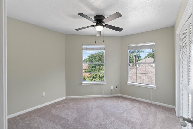 926 Montview Dr, Katy, TX 77450 - unfurnished bedroom featuring multiple windows, carpet floors, a textured ceiling, baseboards, and a ceiling fan