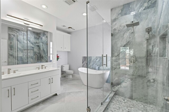 926 Montview Dr, Katy, TX 77450 - full bath featuring marble finish floors, double vanity, a shower stall, a freestanding bath, and recessed lighting
