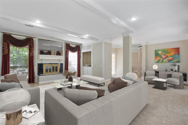 926 Montview Dr, Katy, TX 77450 - living area with crown molding, a glass covered fireplace, recessed lighting, baseboards, and decorative columns
