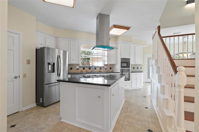 926 Montview Dr, Katy, TX 77450 - kitchen with appliances with stainless steel finishes, island exhaust hood, backsplash, and white cabinets