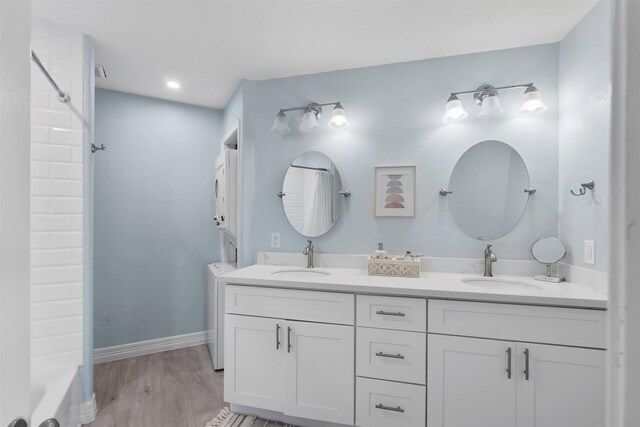 7600 Seawall Blvd Unit 109, Galveston, TX 77551 - bathroom with double vanity, wood finished floors, and washtub / shower combination