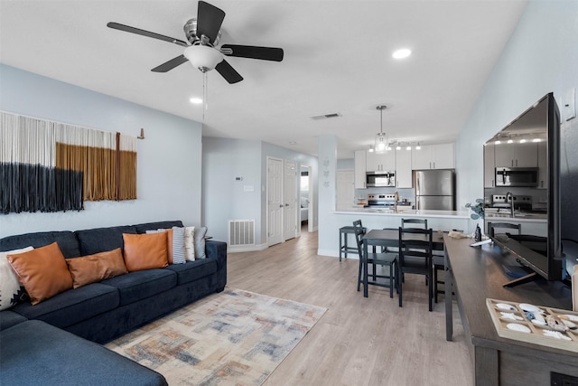 7600 Seawall Blvd Unit 109, Galveston, TX 77551 - living area with ceiling fan, light wood finished floors, recessed lighting, and baseboards