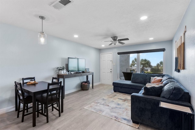 7600 Seawall Blvd Unit 109, Galveston, TX 77551 - living area with wood finished floors, ceiling fan, recessed lighting, baseboards, and a textured ceiling