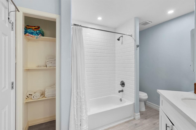 7600 Seawall Blvd Unit 109, Galveston, TX 77551 - bathroom featuring wood finished floors, vanity, shower / bath combo, toilet, and recessed lighting