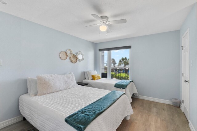 7600 Seawall Blvd Unit 109, Galveston, TX 77551 - bedroom featuring wood finished floors, baseboards, and ceiling fan