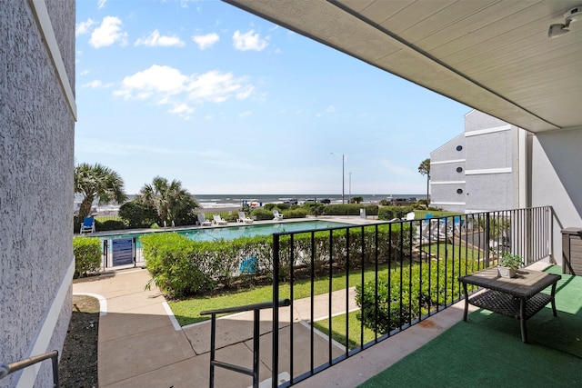 7600 Seawall Blvd Unit 109, Galveston, TX 77551 - balcony featuring view of pool and a water view