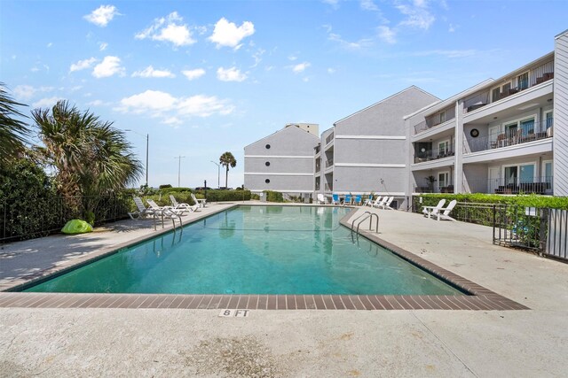 7600 Seawall Blvd Unit 109, Galveston, TX 77551 - community pool featuring a patio