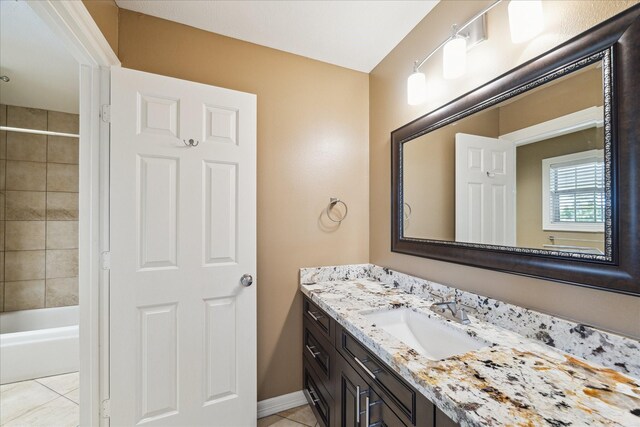 4911 Shiloh Lake Dr, Richmond, TX 77407 - bathroom with vanity, tile patterned flooring, bathing tub / shower combination, and baseboards