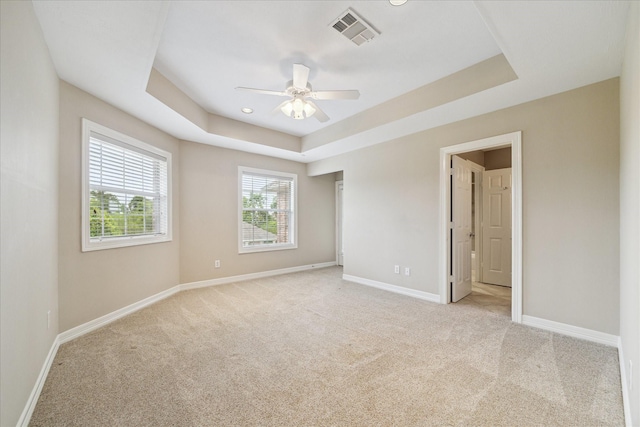 4911 Shiloh Lake Dr, Richmond, TX 77407 - unfurnished bedroom featuring light carpet, baseboards, a raised ceiling, and ceiling fan