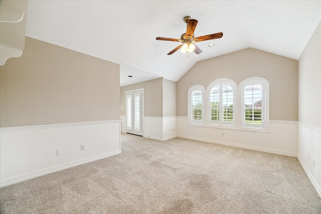 4911 Shiloh Lake Dr, Richmond, TX 77407 - carpeted empty room featuring ceiling fan, vaulted ceiling, and a wainscoted wall