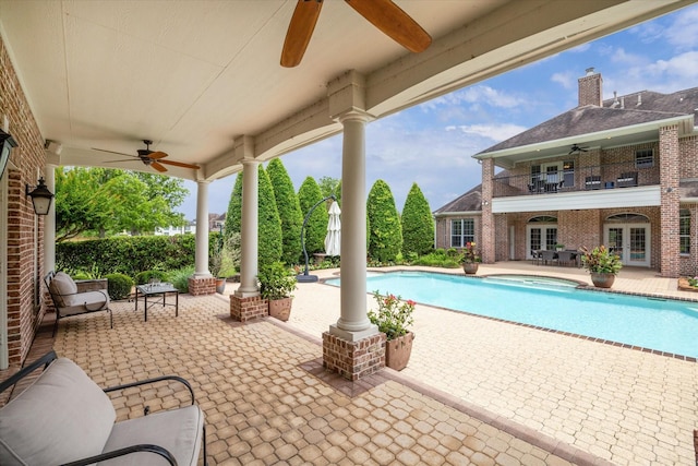 4911 Shiloh Lake Dr, Richmond, TX 77407 - view of patio / terrace featuring ceiling fan, french doors, a balcony, and an outdoor pool