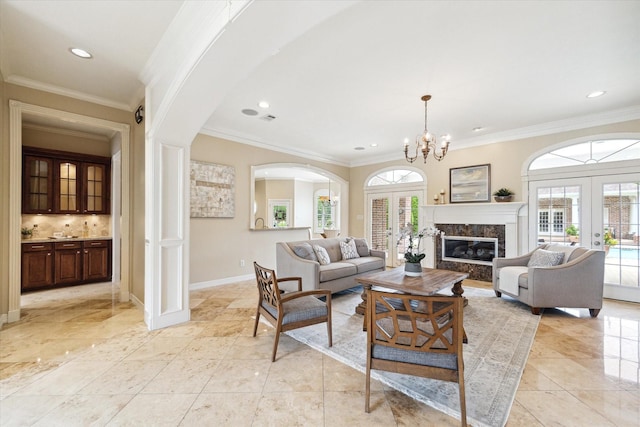 4911 Shiloh Lake Dr, Richmond, TX 77407 - living room featuring french doors, arched walkways, ornamental molding, recessed lighting, and baseboards