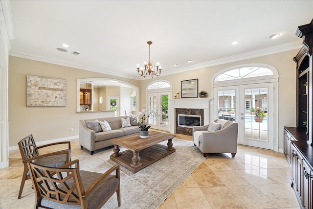 4911 Shiloh Lake Dr, Richmond, TX 77407 - living area featuring french doors, arched walkways, crown molding, baseboards, and recessed lighting