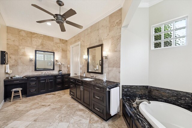 4911 Shiloh Lake Dr, Richmond, TX 77407 - bathroom with tile walls, crown molding, a ceiling fan, two vanities, and a bath
