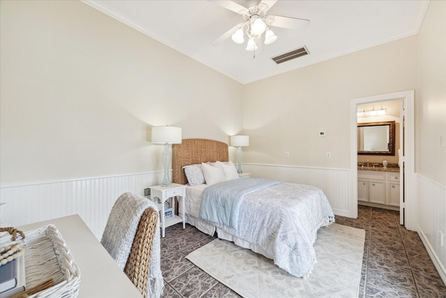 4911 Shiloh Lake Dr, Richmond, TX 77407 - bedroom with wainscoting, ornamental molding, a ceiling fan, connected bathroom, and tile patterned floors