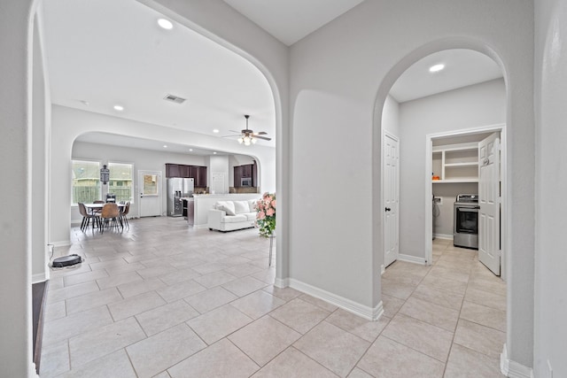 19918 Lizzie Ridge Ln, Cypress, TX 77433 - corridor with arched walkways, recessed lighting, light tile patterned flooring, and baseboards