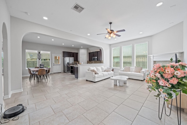 19918 Lizzie Ridge Ln, Cypress, TX 77433 - living room featuring arched walkways, recessed lighting, a ceiling fan, plenty of natural light, and light tile patterned floors
