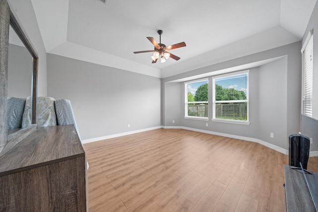 19918 Lizzie Ridge Ln, Cypress, TX 77433 - spare room with a tray ceiling, ceiling fan, light wood-style floors, and baseboards