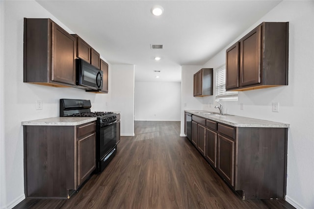 14611 Broadbury Pond Rd, Rosharon, TX 77583 - kitchen featuring black appliances, light countertops, dark wood-type flooring, baseboards, and recessed lighting