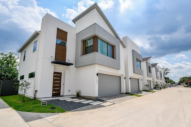 7603 Jacquelyn Gardens Ln, Houston, TX 77055 - contemporary home featuring a garage, stucco siding, and driveway