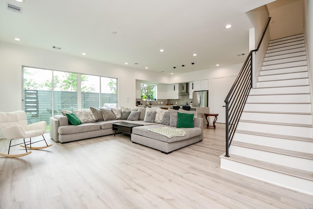7603 Jacquelyn Gardens Ln, Houston, TX 77055 - living area featuring light wood finished floors, stairway, and recessed lighting