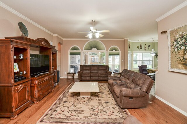 1511 Baldridge Ln, Katy, TX 77494 - living area with wood finished floors, ceiling fan, crown molding, and baseboards