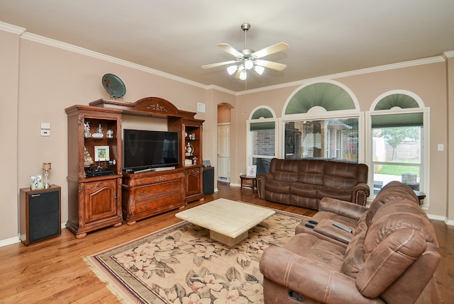 1511 Baldridge Ln, Katy, TX 77494 - living room featuring light wood-type flooring, ceiling fan, ornamental molding, baseboards, and arched walkways