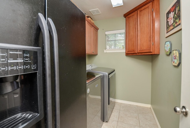 1511 Baldridge Ln, Katy, TX 77494 - laundry area with washer and clothes dryer, cabinet space, light tile patterned floors, and baseboards