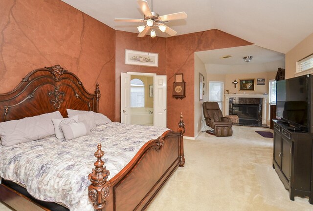 1511 Baldridge Ln, Katy, TX 77494 - bedroom with light colored carpet, vaulted ceiling, a high end fireplace, baseboards, and ceiling fan