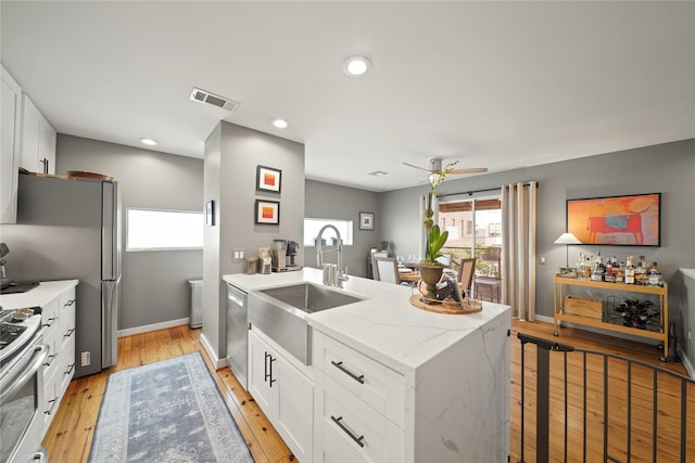 1716 W Dallas St Unit 11, Houston, TX 77019 - kitchen with a sink, white cabinets, a kitchen bar, appliances with stainless steel finishes, and recessed lighting