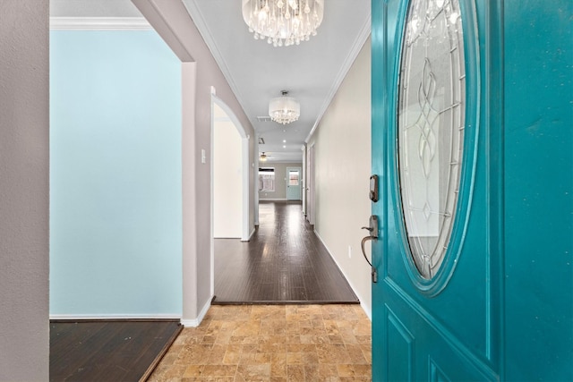 1910 Serenata Ln, Humble, TX 77396 - entryway featuring a chandelier, ornamental molding, arched walkways, stone finish floors, and baseboards