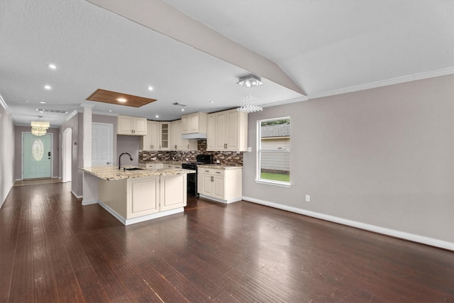 1910 Serenata Ln, Humble, TX 77396 - kitchen with black range with gas cooktop, a chandelier, crown molding, a sink, and baseboards