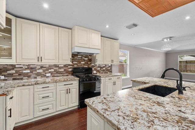1910 Serenata Ln, Humble, TX 77396 - kitchen with gas stove, a sink, dark wood-type flooring, plenty of natural light, and crown molding