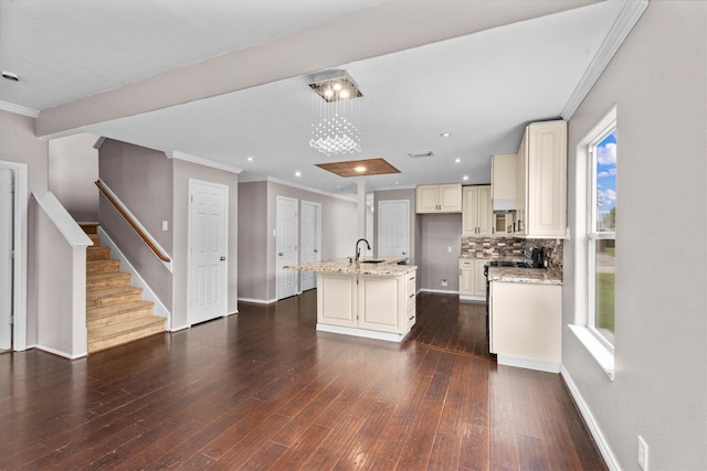 1910 Serenata Ln, Humble, TX 77396 - kitchen with a sink, crown molding, light stone countertops, dark wood finished floors, and a kitchen island with sink