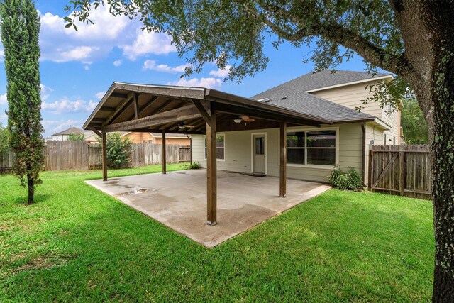 1910 Serenata Ln, Humble, TX 77396 - rear view of house with a ceiling fan, a shingled roof, and a patio area