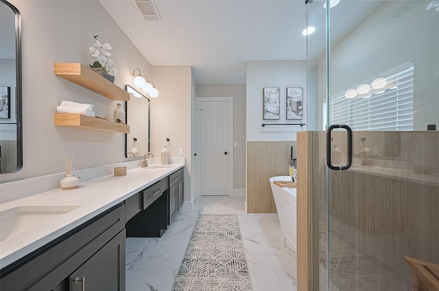 5615 Haven Point Dr, Houston, TX 77084 - bathroom with double vanity, marble look tiles, a soaking tub, wainscoting, and a shower stall