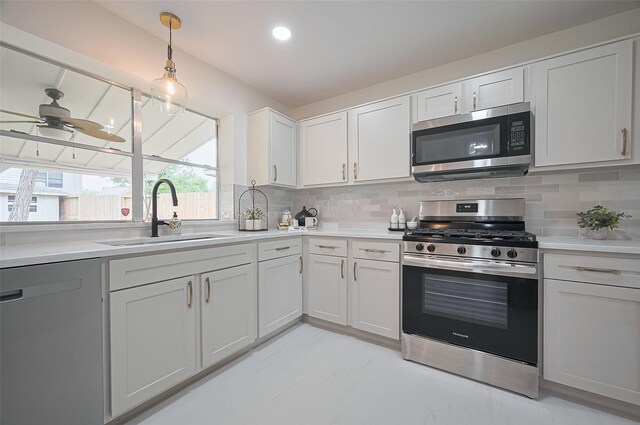 5615 Haven Point Dr, Houston, TX 77084 - kitchen featuring appliances with stainless steel finishes, a sink, decorative backsplash, light countertops, and recessed lighting