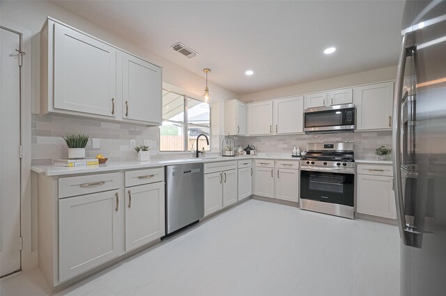 5615 Haven Point Dr, Houston, TX 77084 - kitchen with appliances with stainless steel finishes, decorative backsplash, light countertops, a sink, and recessed lighting