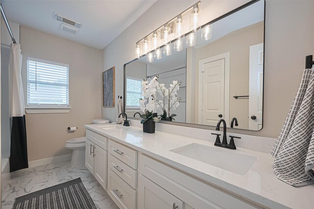5615 Haven Point Dr, Houston, TX 77084 - full bath with marble look tile flooring, toilet, double vanity, curtained shower, and baseboards