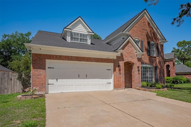 5615 Haven Point Dr, Houston, TX 77084 - traditional-style home featuring brick siding, driveway, roof with shingles, and an attached garage