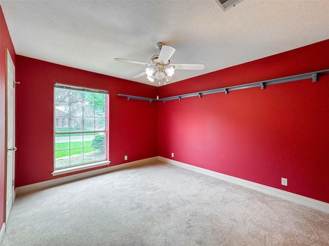 1507 N 24th St, Nederland, TX 77627 - carpeted spare room with a textured ceiling, a ceiling fan, and baseboards