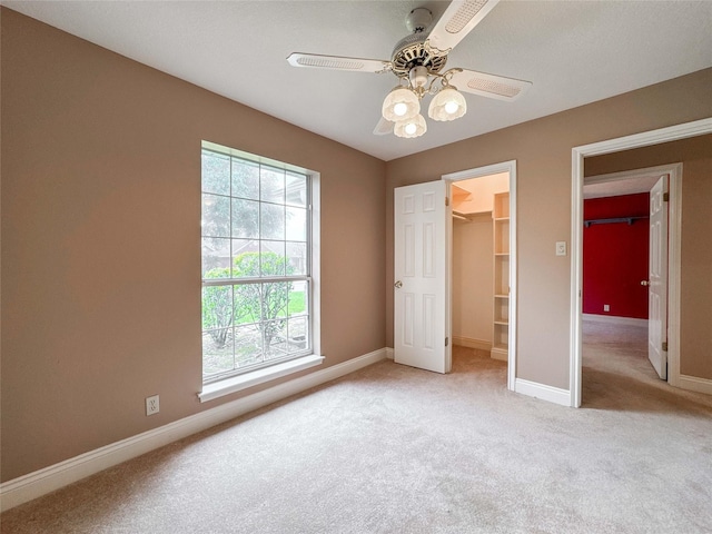 1507 N 24th St, Nederland, TX 77627 - unfurnished bedroom with light carpet, baseboards, a spacious closet, and ceiling fan