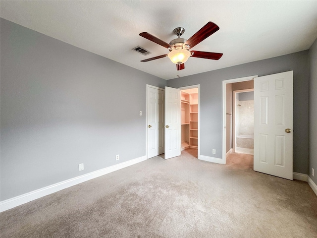 1507 N 24th St, Nederland, TX 77627 - unfurnished bedroom featuring baseboards, light carpet, a closet, and a walk in closet