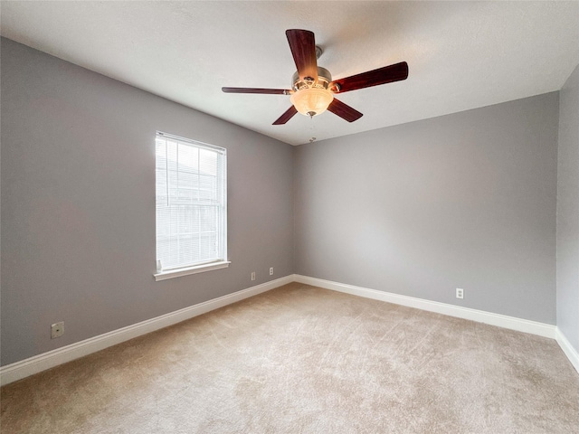 1507 N 24th St, Nederland, TX 77627 - spare room featuring light colored carpet, a ceiling fan, and baseboards