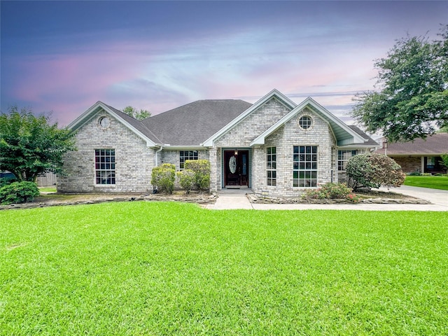 1507 N 24th St, Nederland, TX 77627 - view of front of property featuring a front lawn, brick siding, and roof with shingles