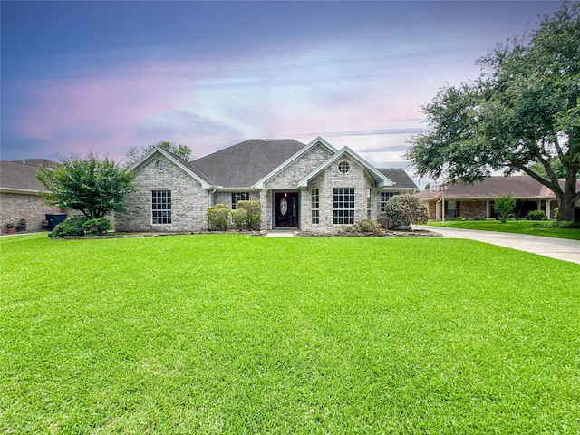 1507 N 24th St, Nederland, TX 77627 - view of front of property with a front yard, stone siding, and brick siding