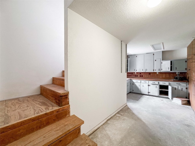 1507 N 24th St, Nederland, TX 77627 - stairs featuring a textured ceiling